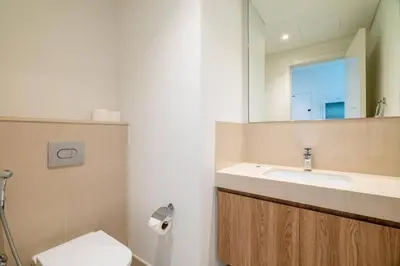 a bathroom with a sink and a toilet and a mirror at Prime Location Full Burj View in Downtown Dubai in Dubai