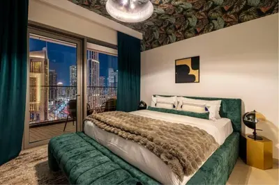 a bedroom with a large bed and a balcony at Prime Location Full Burj View in Downtown Dubai in Dubai