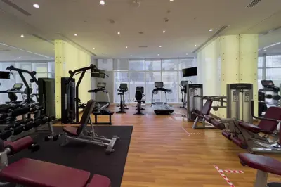 a gym with treadmills and elliptical machines at GuestReady - Charm stay in Dubai Marina in Dubai