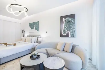 a living room with a couch and a bed at Exquisite Modern Home Minutes from Downtown Dubai in Dubai