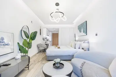 a living room with a bed and a couch at Exquisite Modern Home Minutes from Downtown Dubai in Dubai