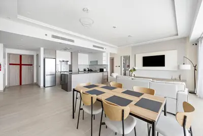 a kitchen and dining room with a table and chairs at 2-Bedroom Apartment in ME DO RE in Dubai