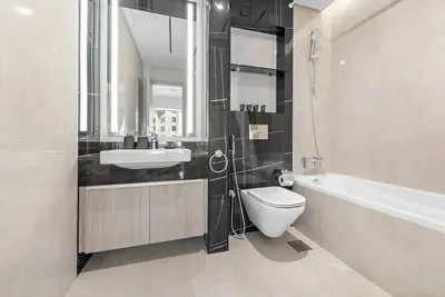 a bathroom with a toilet and a sink and a bath tub at 2-Bedroom Apartment in ME DO RE in Dubai