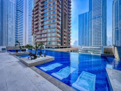 a large swimming pool in a city with tall buildings at 2-Bedroom Apartment in ME DO RE in Dubai