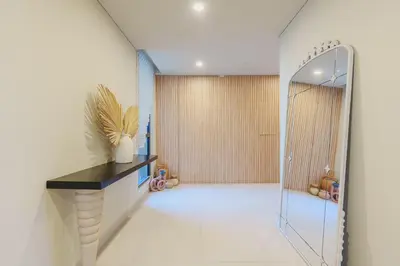 a bathroom with a walk in shower and a mirror at Spacious 4BR in Madinat Jumeirah Living in Dubai