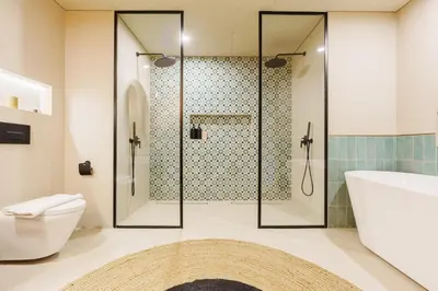 a bathroom with a shower and a toilet and a sink at Spacious 4BR in Madinat Jumeirah Living in Dubai