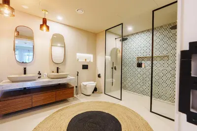 a bathroom with two sinks and a shower at Spacious 4BR in Madinat Jumeirah Living in Dubai
