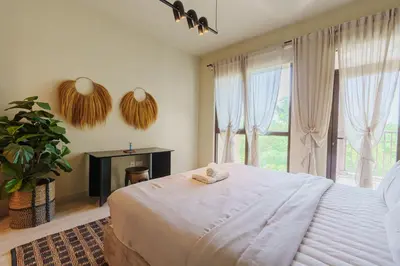 a bedroom with a large bed and a large window at Spacious 4BR in Madinat Jumeirah Living in Dubai