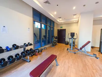 a gym with dumbbells and a bench in a room at EasyGo- Comfy STU in Dubai Marina -Zum04 in Dubai