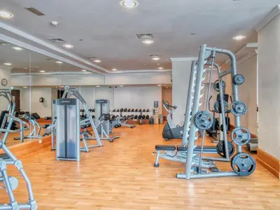 a gym with a bunch of treadms and machines at Classic Retreat in JBR with Private Beach Access in Dubai