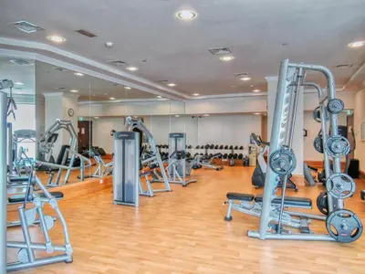 a gym with a lot of treadmills and machines at Classic Retreat in JBR with Private Beach Access in Dubai