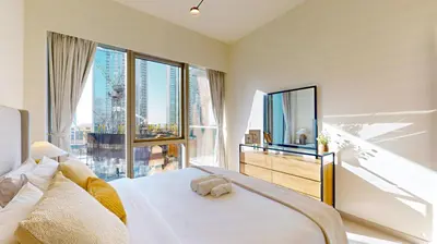 a bedroom with a large bed and a large window at Grande Residence - Contemporary One Bedroom in Dubai