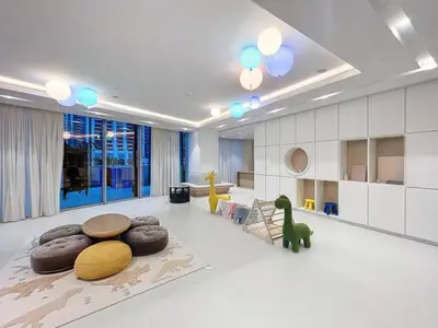 a living room with a dinosaur on the floor at Grande Residence - Contemporary One Bedroom in Dubai