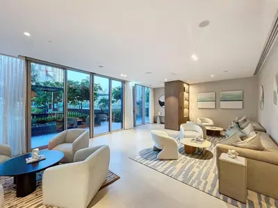 a living room with couches and chairs and a table at Grande Residence - Contemporary One Bedroom in Dubai