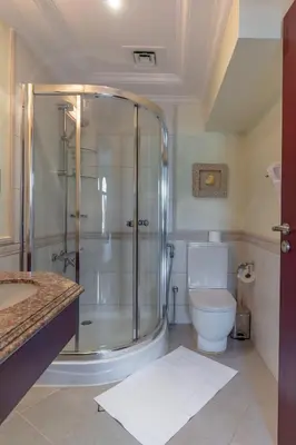 a bathroom with a shower and a toilet at Private Pool & Direct Beach Access-4BDR Villa in Dubai