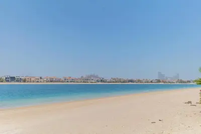 a view of a beach with buildings in the background at Private Pool & Direct Beach Access-4BDR Villa in Dubai