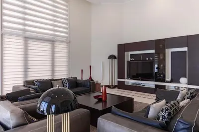 a living room with a couch and a table at Private Pool & Direct Beach Access-4BDR Villa in Dubai