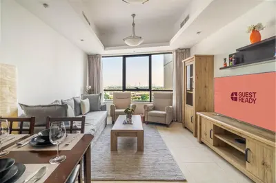 a living room with a couch and a table at GuestReady - Modern retreat in JLT in Dubai