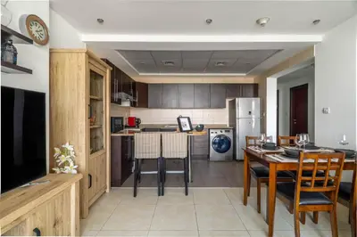 a kitchen and dining room with a table and chairs at GuestReady - Modern retreat in JLT in Dubai