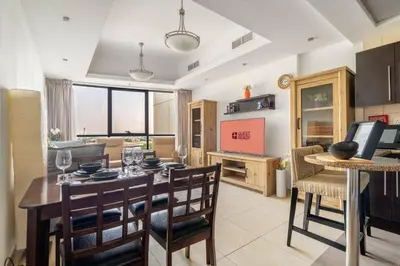 a kitchen and dining room with a table and chairs at GuestReady - Modern retreat in JLT in Dubai