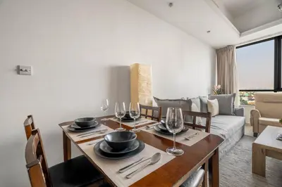 a dining room with a table with wine glasses at GuestReady - Modern retreat in JLT in Dubai