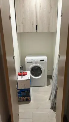 a washer and dryer in a small room at Luxury apartment in Sobha Hartland Waves near Dubai mall and Burj Khalifa in Dubai
