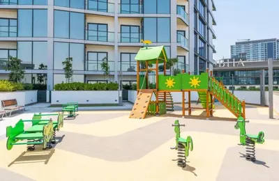 a playground with a slide in front of a building at Luxury apartment in Sobha Hartland Waves near Dubai mall and Burj Khalifa in Dubai