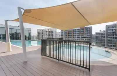 a balcony with a swimming pool on a building at Luxury apartment in Sobha Hartland Waves near Dubai mall and Burj Khalifa in Dubai