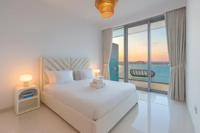a bedroom with a bed with a view of the ocean at Pure Voyage Beachfront in Dubai