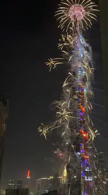 a christmas tree is lit up with fireworks at Luxury High Floor 1BR with Full Burj Khalifa View by Auberge in Dubai