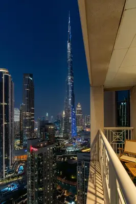 a view of a city skyline at night at Luxury High Floor 1BR with Full Burj Khalifa View by Auberge in Dubai