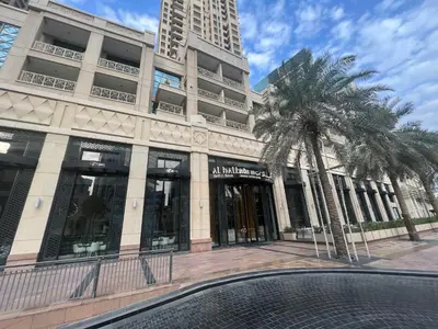 a building with a palm tree in front of it at Luxury High Floor 1BR with Full Burj Khalifa View by Auberge in Dubai