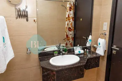 a bathroom with a sink and a mirror at Bloomfields Cozy 1br In Silicon Oasis in Dubai