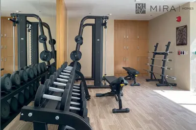 a gym with treadmills and exercise equipment in a building at Mira Holiday Homes - Luxury and cosy 1 bedroom in JVC in Dubai