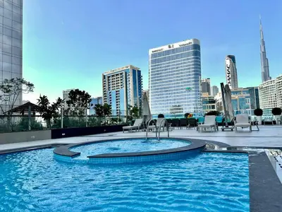a large swimming pool on the roof of a building at Prime Location , Bright Studio , High Floor in Dubai