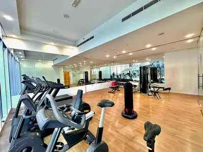 a gym with treadmills and cardio equipment in a building at Prime Location , Bright Studio , High Floor in Dubai