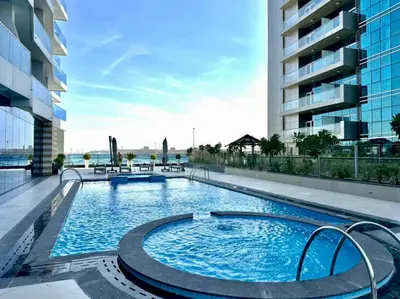 a large swimming pool on the roof of a building at Prime Location , Bright Studio , High Floor in Dubai
