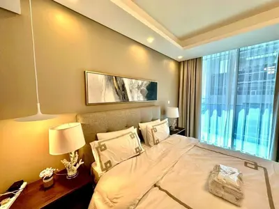 a bedroom with a large bed and a window at Prime Location , Bright Studio , High Floor in Dubai