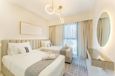 a hotel room with two beds and a mirror at 2 Br in in Burj Crown by Pk Holidays in Dubai