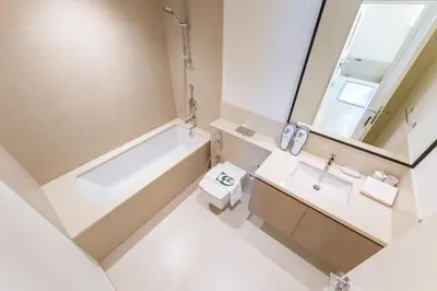 a bathroom with a tub and a sink and a mirror at 2 Br in in Burj Crown by Pk Holidays in Dubai