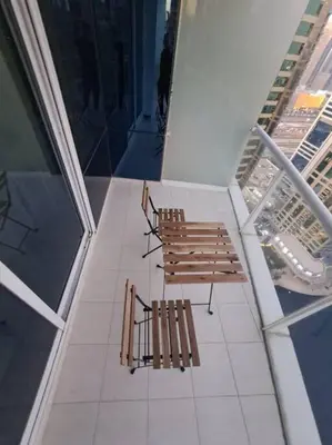 two benches sitting on top of a building at Spacious 1BR unit with Lake View in Dubai