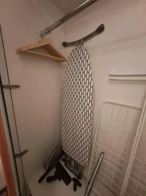 a room with a wall with a racket and shelves at Spacious 1BR unit with Lake View in Dubai