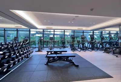 a gym with a lot of treadmills and ellipticals at Luxury 2BR at Address Opera Downtown City View in Dubai
