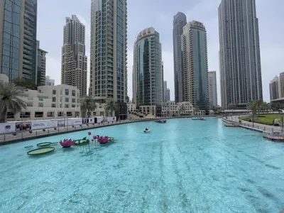 a large swimming pool in a city with tall buildings at Luxury 2BR at Address Opera Downtown City View in Dubai