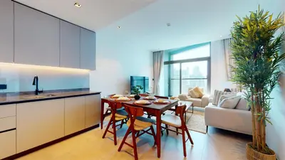 a kitchen and living room with a table and chairs at Burj Khalifa & Lagoon View , Private 1 Bedroom in Dubai