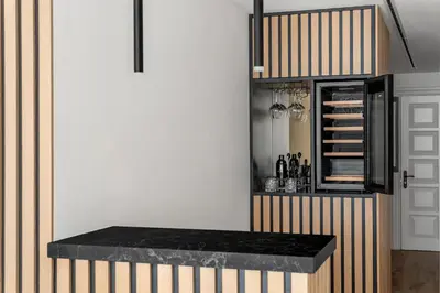 a kitchen with a counter and a cabinet with wine bottles at Silkhaus Chic 3BDR & maid room in Dubai Marina in Dubai