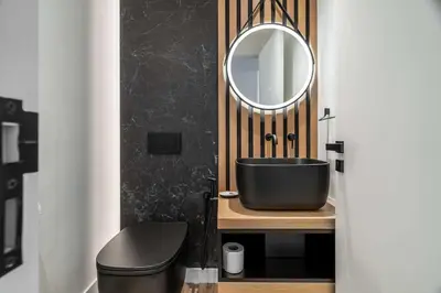 a bathroom with a black sink and a mirror at Silkhaus Chic 3BDR & maid room in Dubai Marina in Dubai