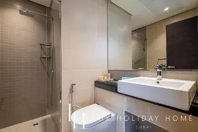 a bathroom with a sink and a mirror at LUX The Silverene Marina View Suite 4 in Dubai