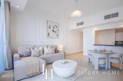 a living room with a couch and a table at LUX The Silverene Marina View Suite 4 in Dubai