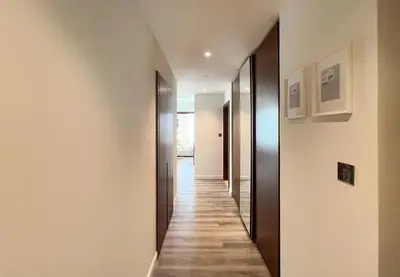 a hallway of a house with wooden floors at Livbnb - 2BR Apartment with Breathtaking Marina View in Dubai